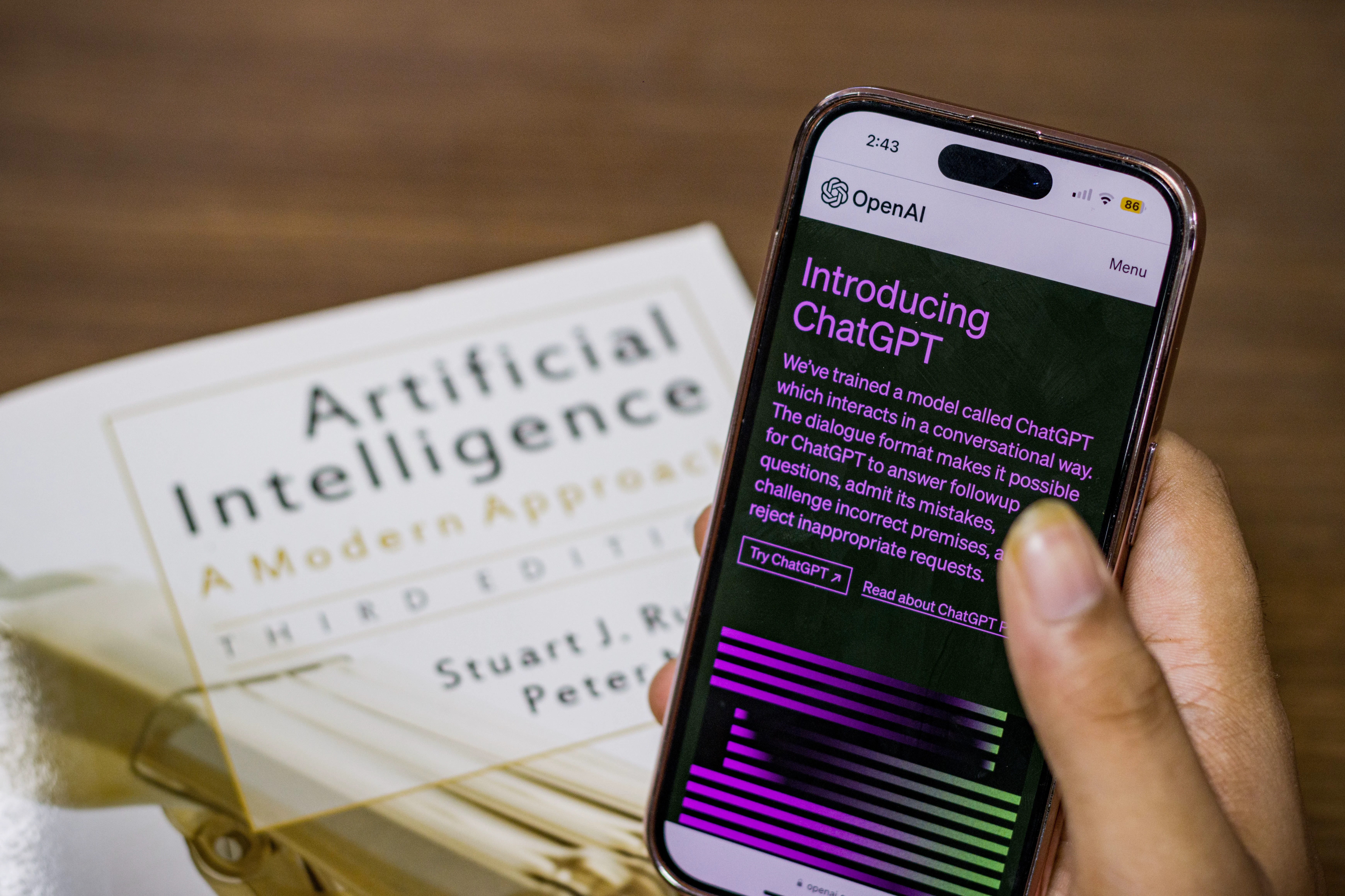 A smartphone displaying an AI chat interface on an open book, illustrating the need to govern agent access and incidents