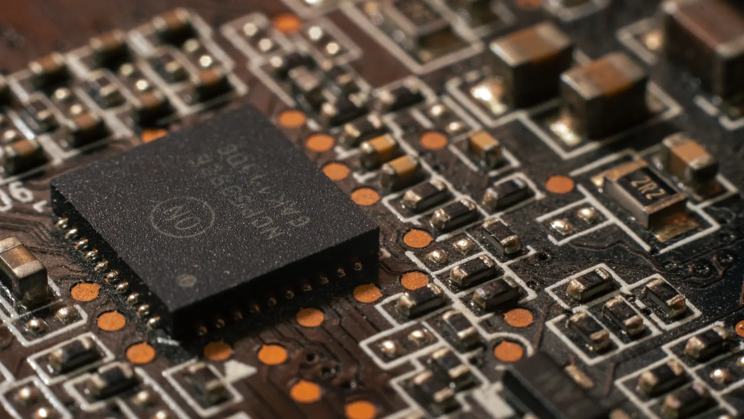 Illustrative close-up of a computer circuit board and chip, not a Besi tool or an HBM stack