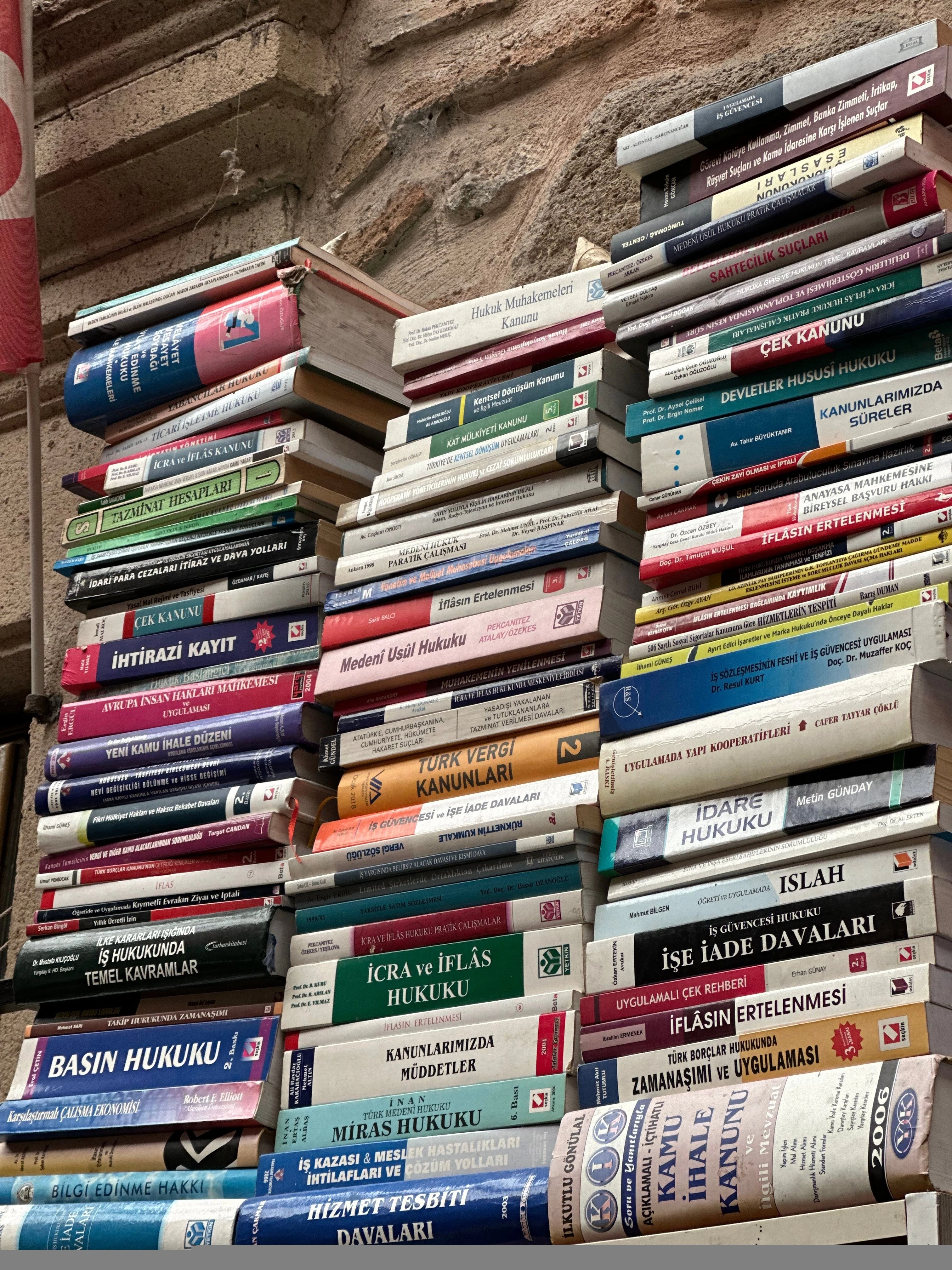 A stack of legal and administrative books, illustrating assessed legal work and responsible AI-use rules