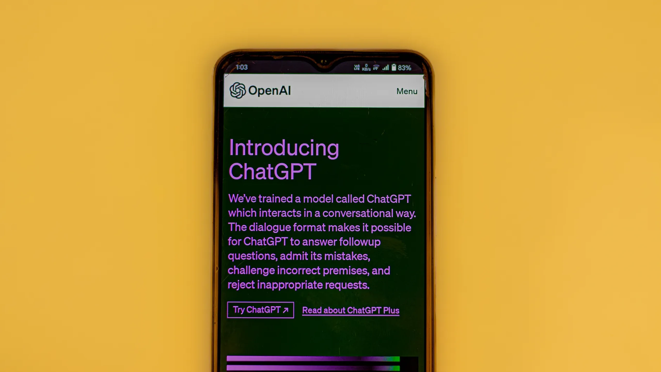 Smartphone displaying the OpenAI ChatGPT page on a yellow background